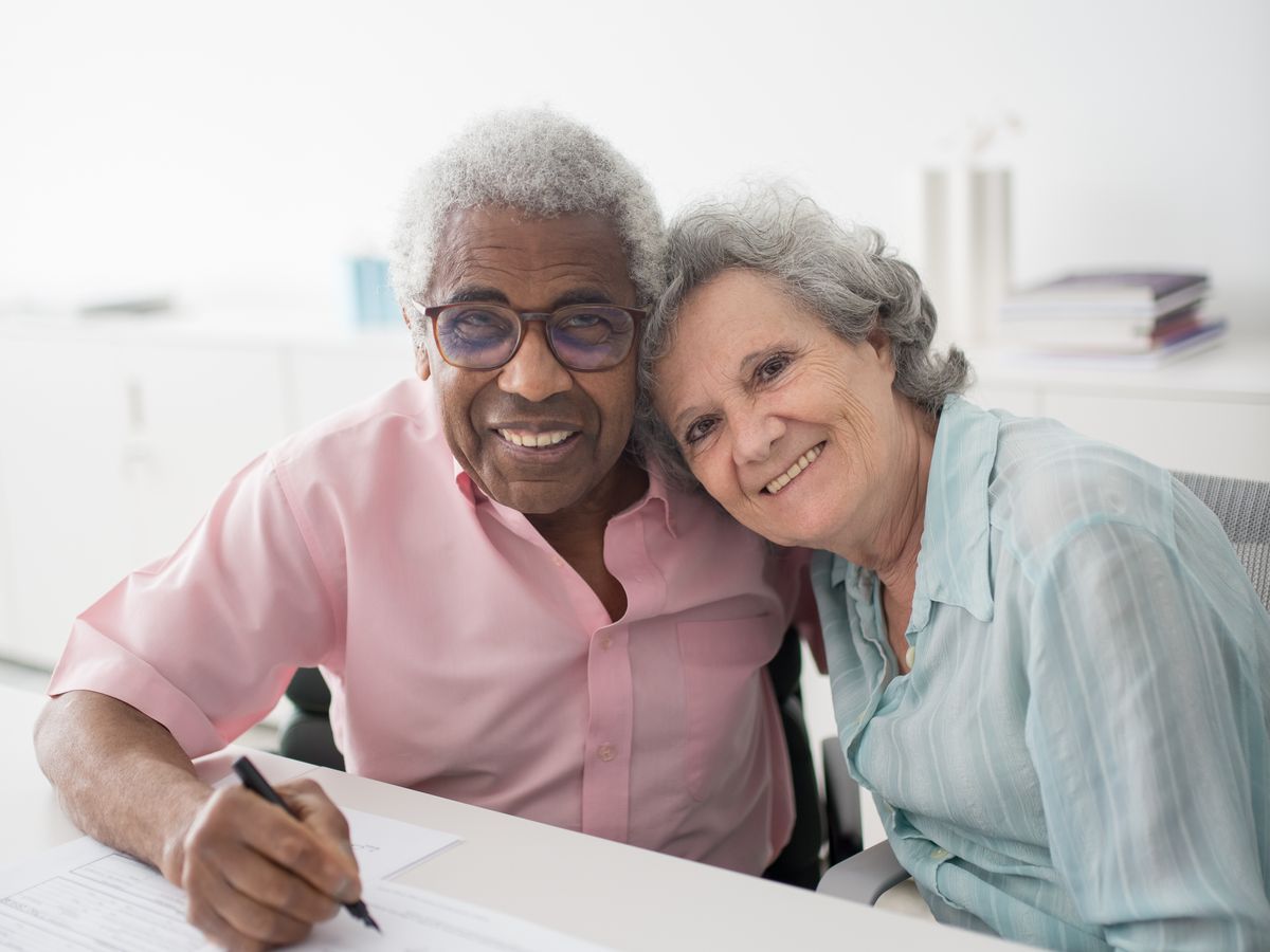 A couple reviewing paperwork together at a bright desk